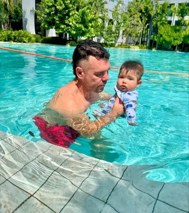 Doctor Bart Scanlon swimming in pool with children