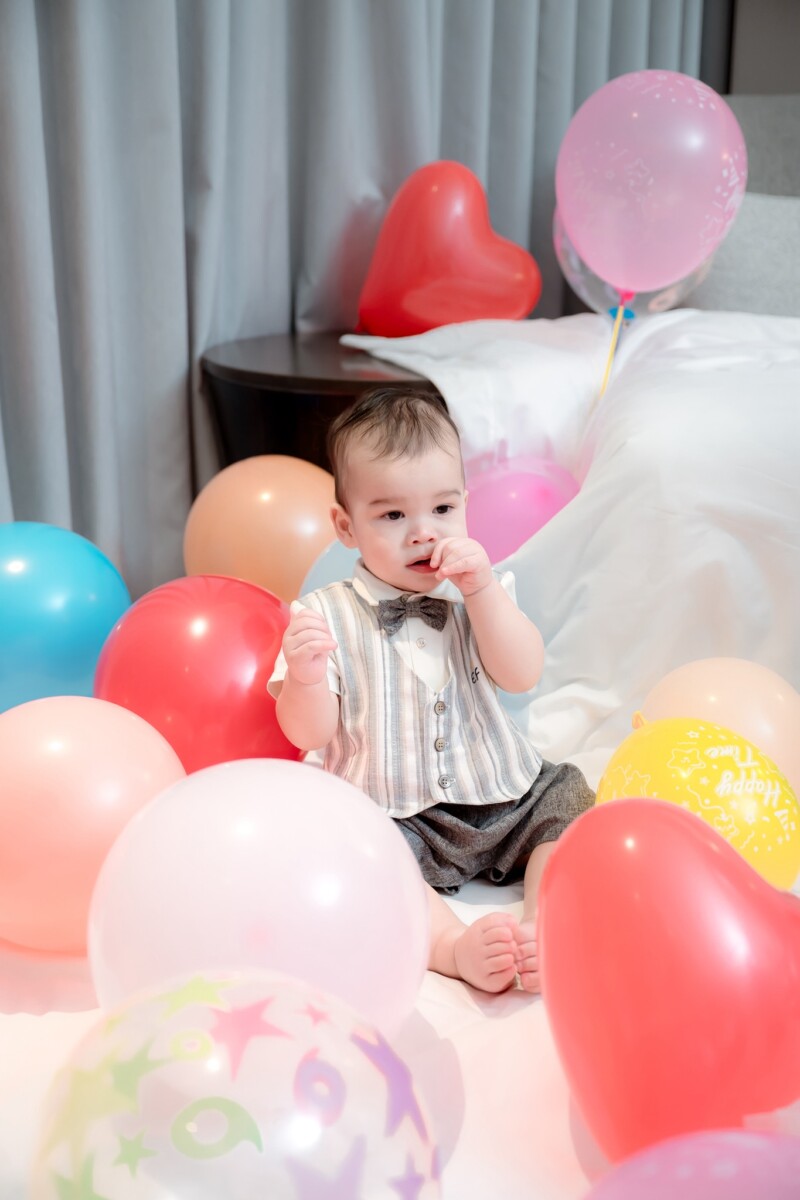 Johnny surrounded by balloons during celebration