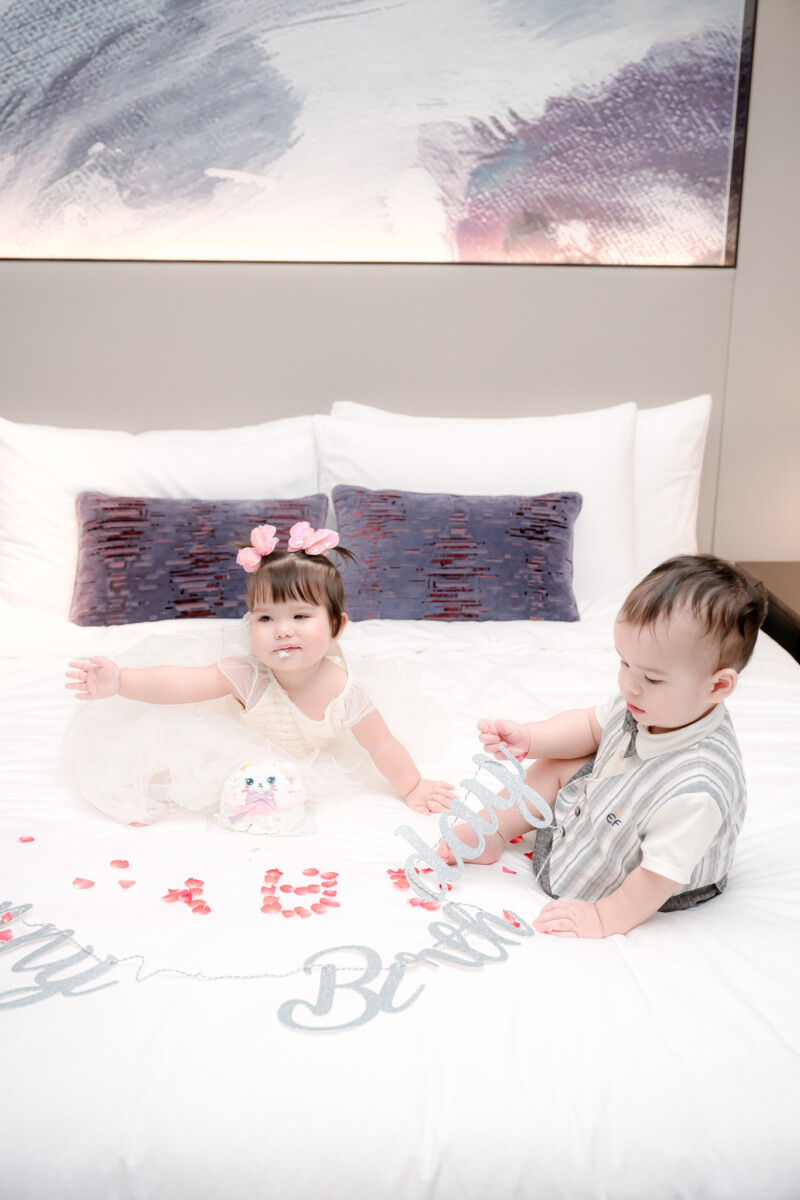 Johnny and Trudy sitting on bed playing
